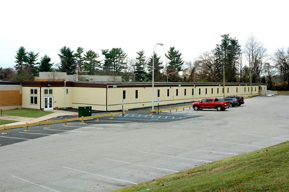 Mobilease Modular Space parking lot in Pedricktown, NJ, with a building visible in the background