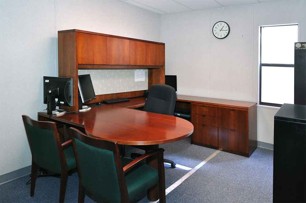 Interior office space inside a modular building featuring wood furniture in USA