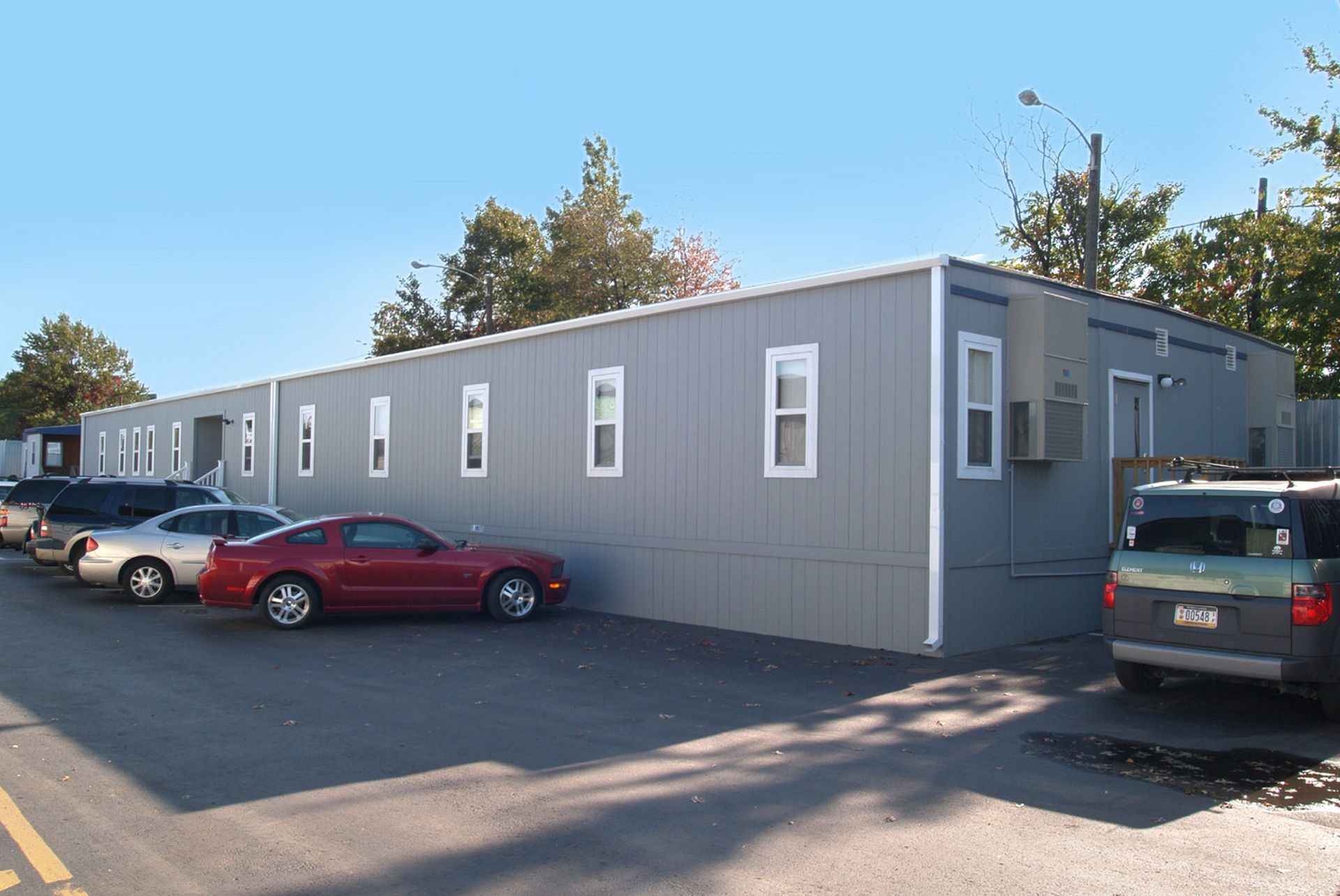 Vehicles parked in front of a modular commercial facility in the USA