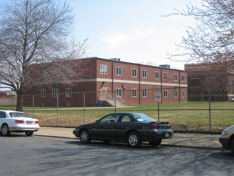 A car parked on the roadside in Pedricktown, NJ, near a site featuring Modular Classroom Solutions
